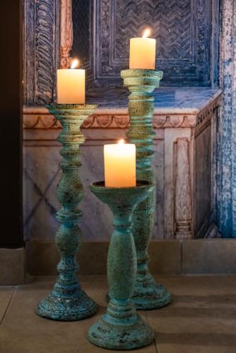 two candles in vases sitting in front of a fireplace at Il Gentiluomo Hotel & SPA in Arezzo