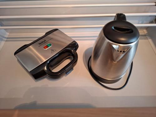 a tea kettle sitting on top of a refrigerator at Maluma in Izola