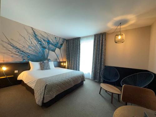 a bedroom with a bed and a large painting on the wall at The Originals Boutique, Hôtel de la Paix, Brest in Brest