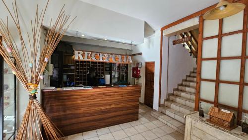 a restaurant with a barrior sign on the wall at Hotel Koliba na Grza in Kilsura