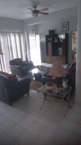 a living room with couches and a table at Tranquila Oasis in Runaway Bay
