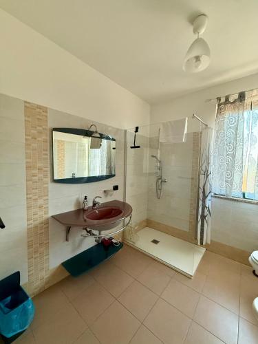 a bathroom with a sink and a shower at Affittacamere Karma Rho-Fiera in Rho