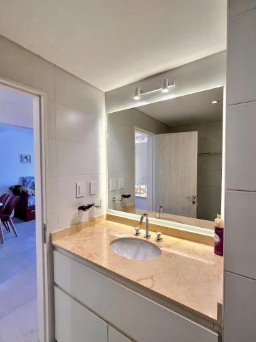 a bathroom with a sink and a large mirror at Augusto Apart 4 in Salta