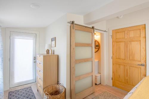 a bedroom with a closet and a wooden door at Lakeshore Vermont in Colchester