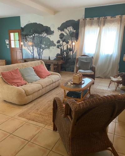 a living room with a couch and a table at La Petite Toscane en Beaujolais in Saint-Vérand