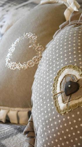 a pillow with a heart on it with a chain on it at Monica's apartment Mansarda - Stella Alpina in Sauze dʼOulx