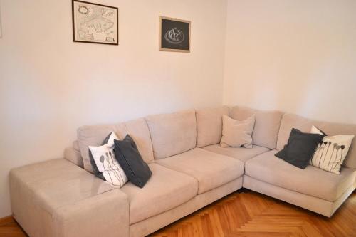 a living room with a couch with pillows on it at Maluma in Izola