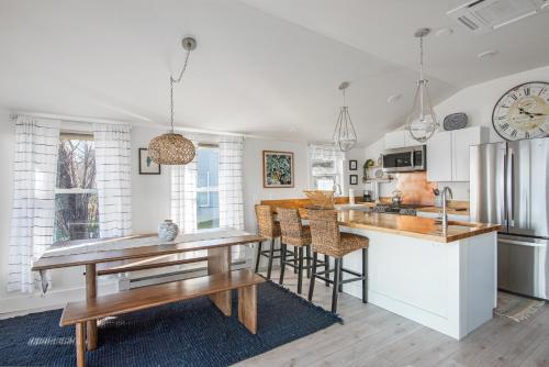 a kitchen with a table and chairs and a counter at Lakeshore Vermont in Colchester