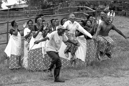 a group of people dancing in front of a fence at Kalih Villa in Kigali