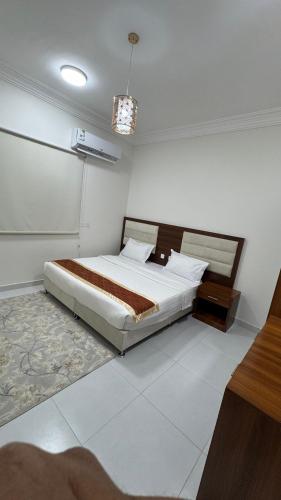 a bedroom with a large bed in a room at Evora إيفورا in Sharurah