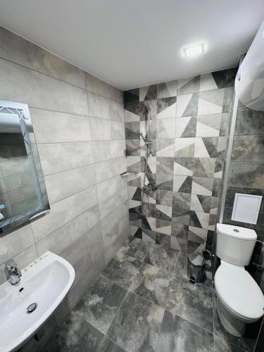 a bathroom with a toilet and a sink at July apartaments in Velingrad