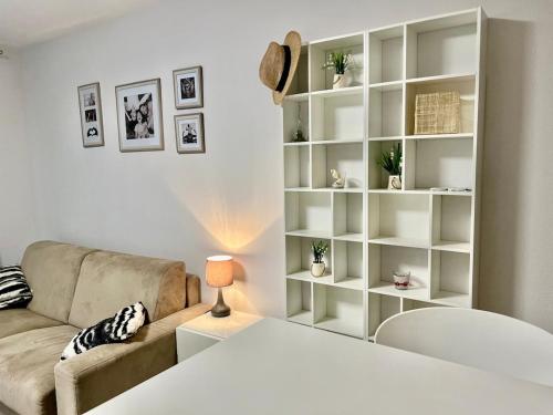 a living room with a couch and a book shelf at Monaco border, 2-room Josephine, pool, Bnb Rickeys in Beausoleil