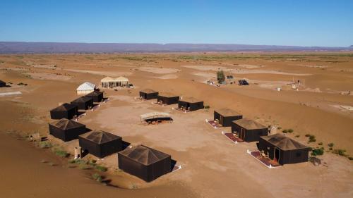 an aerial view of a camp in the desert at Erg Chigaga Torza Luxury Camp - Desert Glamping in El Gouera