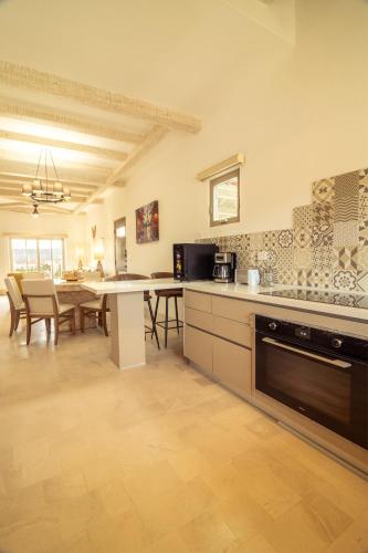 a kitchen with a table and a dining room at Pueblo parvada 24 in Ejido Parras