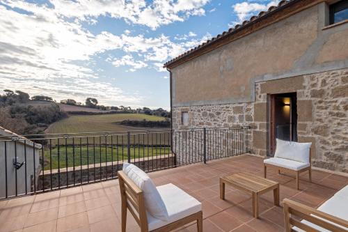a patio with a view of the countryside from a house at Cal Trumfet in Caserras