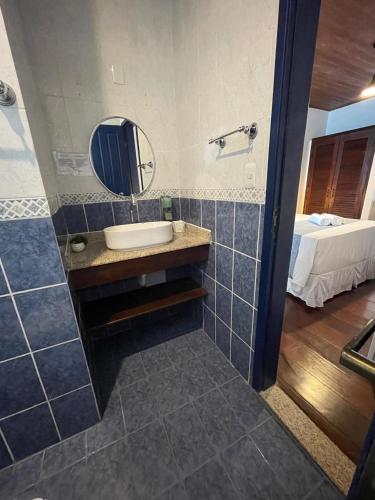 a bathroom with a sink and a mirror at Pousada Beija Flor in Salvador
