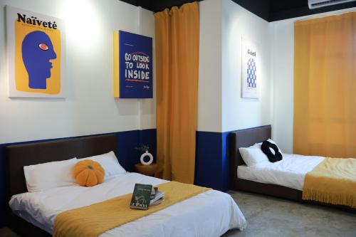 a room with two beds and a sign on the wall at 嘿夏天 HeySummer-13pax l 200mJetty l Netflix l Games l Youtube in Mersing