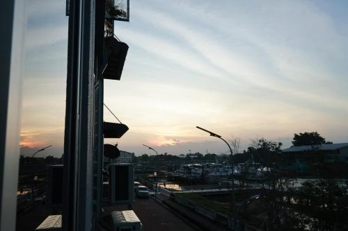 a view from a window of a city at sunset at 嘿夏天 HeySummer-13pax l 200mJetty l Netflix l Games l Youtube in Mersing