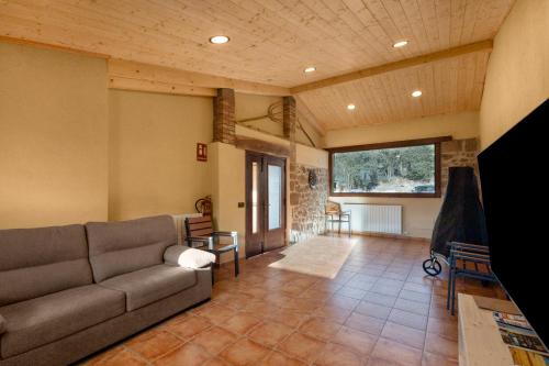 a living room with a couch and a table at Cal Trumfet in Caserras