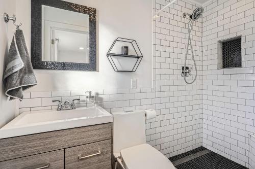 a white bathroom with a sink and a mirror at Spacious Denver home in Denver