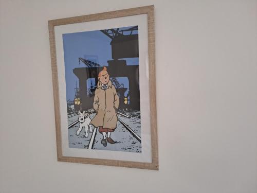 a framed picture of a man and a dog on the tracks at Be Zen ô Bizet Appartement moderne ultra confort jusqu'à 5 personnes in Le Bizet
