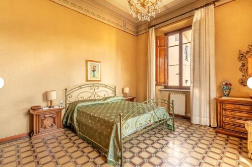 a bedroom with a bed and a window at Guest House Villa Lenzi - Dimora Storica in Lucca