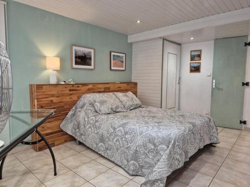 une chambre avec un lit et une table en verre dans l'établissement La maison du bonheur, à Pessac