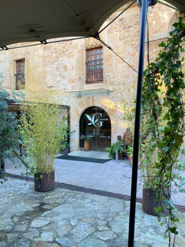 an umbrella in front of a building with plants at Los Guardeses in Solares