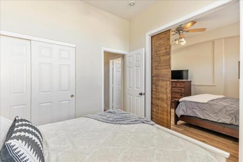 a bedroom with a bed and a dresser and a mirror at Henderson Hacienda, 5br free heated pool-spa, 15 min to Strip in Henderson