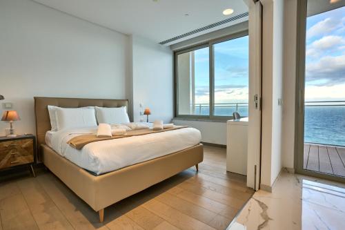 a bedroom with a bed with a view of the ocean at Coastal One Bedroom Retreat with direct Breathtaking Sea Views in Sliema