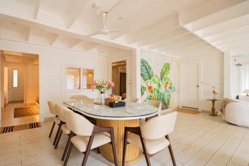 a dining room with a table and chairs at ELIVAAS House of Neptune - 3 BHK Cottage with Terrace & Gazebo on the Beach in Morjim