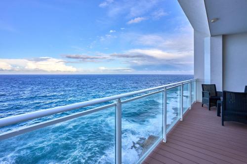 a balcony on a cruise ship looking at the ocean at Coastal One Bedroom Retreat with direct Breathtaking Sea Views in Sliema