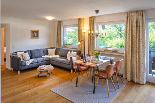 a living room with a couch and a table at Suite Werdenfels in Garmisch-Partenkirchen