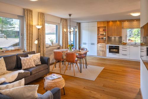 a living room with a couch and a table at Suite Werdenfels in Garmisch-Partenkirchen