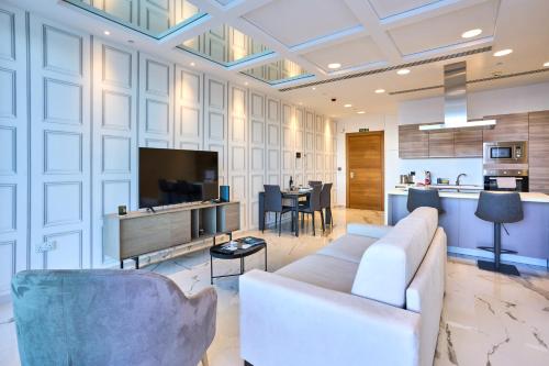 a living room with a couch and a tv at Coastal One Bedroom Retreat with direct Breathtaking Sea Views in Sliema