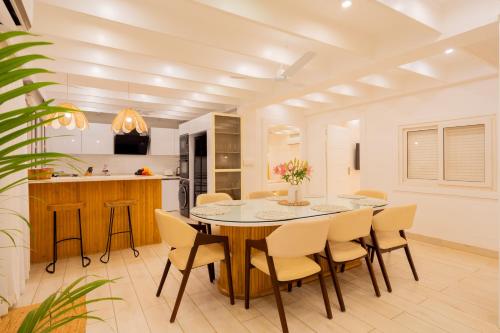 a kitchen and dining room with a table and chairs at ELIVAAS House of Neptune - 3 BHK Cottage with Terrace & Gazebo on the Beach in Morjim