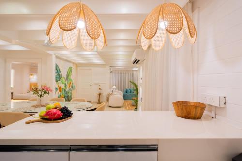 a kitchen with a counter with a bowl of fruit on it at ELIVAAS House of Neptune - 3 BHK Cottage with Terrace & Gazebo on the Beach in Morjim