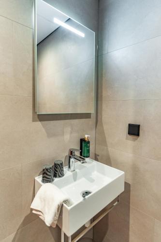 a bathroom with a white sink and a mirror at Martini Hotel in Groningen