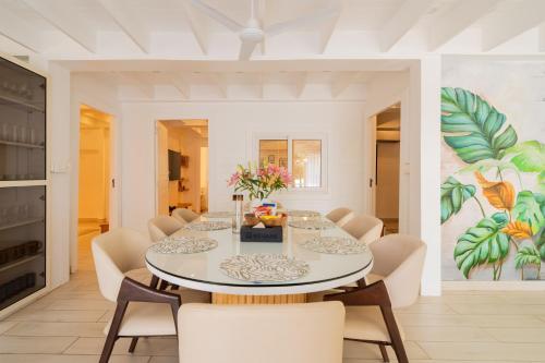 a dining room with a table and chairs at ELIVAAS House of Neptune - 3 BHK Cottage with Terrace & Gazebo on the Beach in Morjim