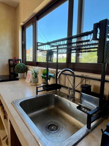 a kitchen with a sink and a large window at Mar y Chelo Luxury Aparments in Isla Mujeres