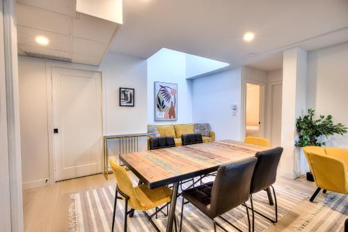 a dining room with a table and chairs at Montreal Restful Nights, Adventure Days await! in Montréal