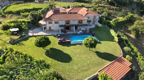 an aerial view of a house with a swimming pool at O Beiral da Anastácia in Marco de Canaveses