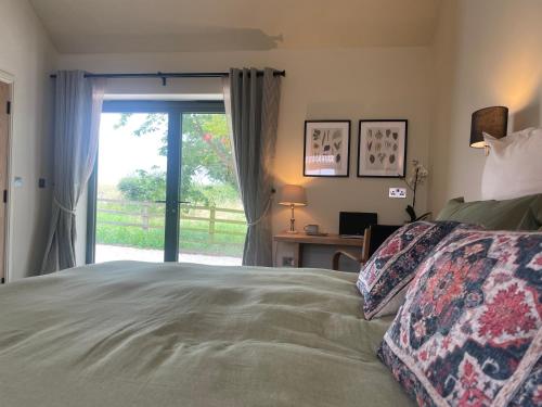 a bedroom with a bed and a sliding glass door at Rural Retreat, 1 bed, sleeps 2 near Bleasby in Bleasby