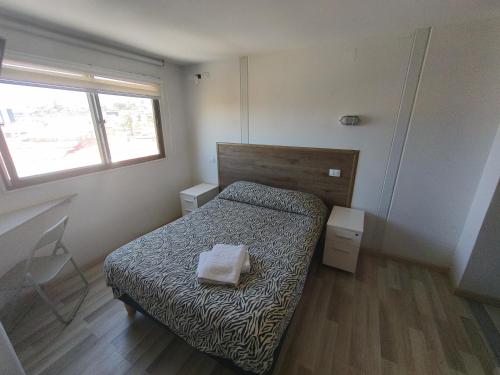 Ένα ή περισσότερα κρεβάτια σε δωμάτιο στο Hostal del Viajero
