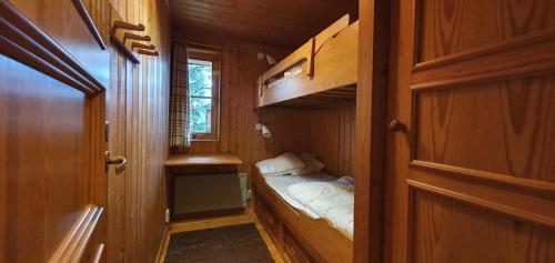 a small room with a small bed in a cabin at Sauna | Wi-Fi | Terrace | Wood stove | Cable TV in Lofsdalen