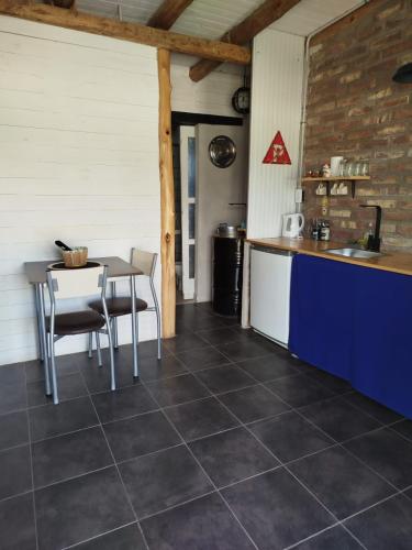 a kitchen with a table and chairs in a room at Posada Malbec in Uspallata