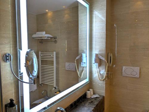 a bathroom with a shower with a mirror and a sink at Il Gentiluomo Hotel & SPA in Arezzo
