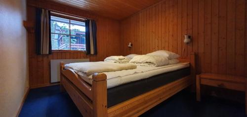 a bedroom with a bed in a room with a window at Sauna | Wi-Fi | Terrace | Wood stove | Cable TV in Lofsdalen