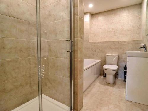 a bathroom with a shower and a toilet at Little Rissington - Barn Four in Little Rissington