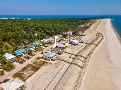 an aerial view of a beach with houses and the ocean at Pour House in Dauphin Island